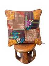 Handcrafted pillow made from colorful huipil remnants in a radial starburst pattern.- FolkProject