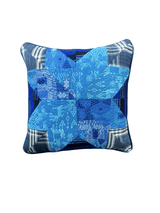 Handcrafted pillow made from colorful huipil remnants in a radial starburst pattern.- FolkProject