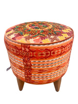 Round footstool upholstered in colorful Guatemalan huipil with rich caramel Belgian velvet piping - FolkProject