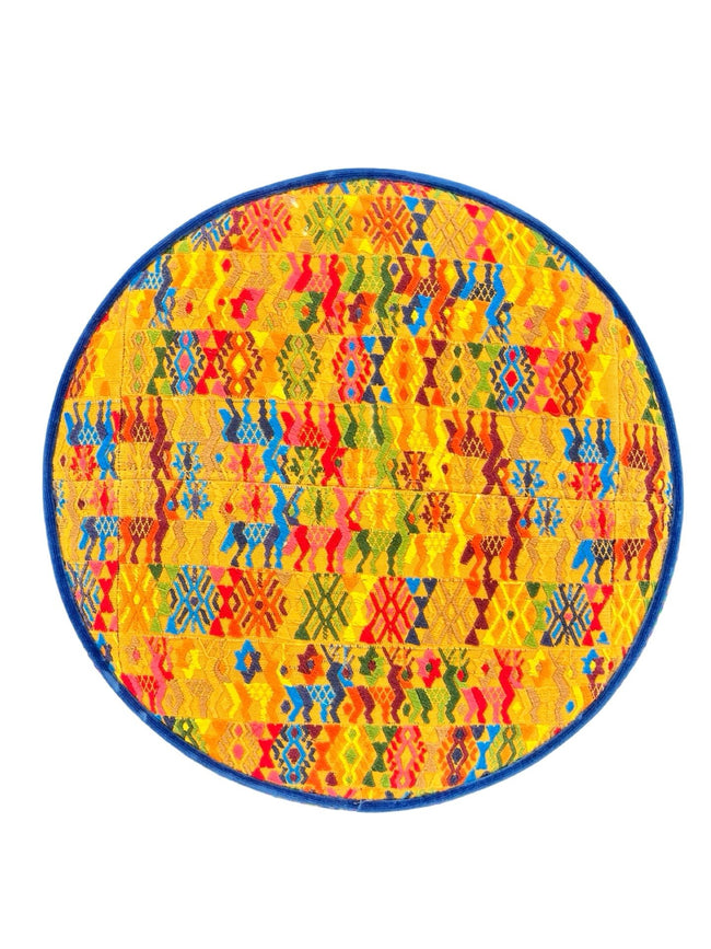 Round footstool upholstered in colorful Guatemalan huipil with rich blue Belgian velvet piping- FolkProject