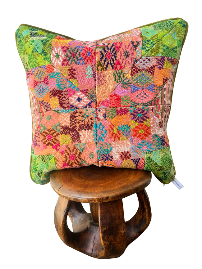Handcrafted pillow made from colorful huipil remnants in a radial starburst pattern
- FolkProject
